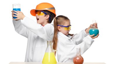 Two cute children at chemistry lesson making experiments Two cute children at chemistry lesson making experiments isolated on white background